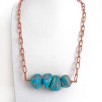 This chunky turquoise necklace features big, organically-shaped nuggets of genuine natural turquoise accented with a copper link chain. The turquoise is a stunning shade of blue - reminiscent of the lovely blue skies here in the American Southwest. Unique and one-of-a-kind, it will make a bold statement. Perfect for women that love bold unique jewelry made with natural stones. Handmade in the USA by Silver and Earth Jewelry. 