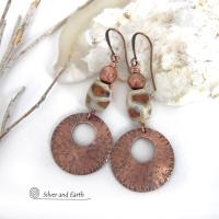 These handcrafted copper earrings have a bold, ethnic African style and flair. They feature round copper dangles with a rustic hammered texture accented with African etched giraffe print agate stones topped off with solid copper beads. Unique and striking, they'll make a bold statement. Perfect for women that love ethnic tribal style jewelry. Handmade in the USA by Silver and Earth Jewelry. 