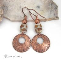 These handcrafted copper earrings have a bold, ethnic African style and flair. They feature round copper dangles with a rustic hammered texture accented with African etched giraffe print agate stones topped off with solid copper beads. Unique and striking, they'll make a bold statement. Perfect for women that love ethnic tribal style jewelry. Your choice of ear wire - copper or hypoallergenic niobium.