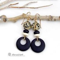 These handcrafted earrings feature matte black glass circle hoops accented with Dalmatian jasper gemstones, African bone and black glass beads. Unique and fun to wear, they have an earthy natural style with boho chic flair that makes a striking statement. They'll make a great gift for a natural stone lover - or a nice addition to your own jewelry wardrobe. Handmade in the USA by Silver and Earth Jewelry. 