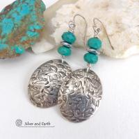 Handcrafted earrings with sterling silver oval dangles with a hand stamped texture accented with natural turquoise and hematite gemstones. The stones have a faceted finish which casts off a natural sparkle and shine. They have a modern style with southwestern flair that looks great with all wardrobe types. Perfect for women that love modern style southwest jewelry. Handmade in the USA by Silver and Earth Jewelry, a New Mexico True Certified business.