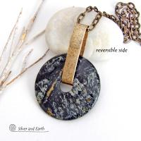 This one-of-a-kind pendant necklace has a large stunning fireworks jasper stone accented with a hand forged gold brass bail. The stone has a natural bold dramatic pattern in hues of black, gold, mint green and cream. The design is modern and bold - yet classic and always in fashion. It can be worn by either a man or women. It's reversible and can be worn on either side. Makes a great gift for a natural stone lover. Handmade in the USA by Silver and Earth Jewelry.