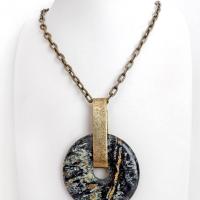 This one-of-a-kind pendant necklace has a large stunning fireworks jasper stone accented with a hand forged gold brass bail. The stone has a natural bold dramatic pattern in hues of black, gold, mint green and cream. The design is modern and bold - yet classic and always in fashion. It can be worn by either a man or women. It's reversible and can be worn on either side. Makes a great gift for a natural stone lover. Handmade in the USA by Silver and Earth Jewelry.