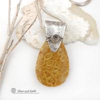 This unique *one-of-a-kind* necklace features a gorgeous fossil coral stone accented with a handcrafted sterling silver bail. Agatized fossil coral is a natural stone formed when ancient coral is gradually replaced with agate. The fossilized coral appear as small "flower-like" markings in the stone, resulting in terrific patterns. This necklace will make a great gift for anyone that loves natural stone jewelry -- or a nice addition to your own jewelry collection.