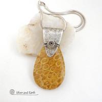 This unique *one-of-a-kind* necklace features a gorgeous fossil coral stone accented with a handcrafted sterling silver bail. Agatized fossil coral is a natural stone formed when ancient coral is gradually replaced with agate. The fossilized coral appear as small "flower-like" markings in the stone, resulting in terrific patterns. This necklace will make a great gift for anyone that loves natural stone jewelry -- or a nice addition to your own jewelry collection.