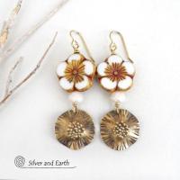 These handcrafted earrings feature large stunning white glass flower beads with golden highlights accented with gold brass dangles with a hand textured design and white faceted crystal beads which add sparkle and shine. They have an elegant, modern chic style and will make a great gift for anyone that loves flowers and nature. Perfect for your spring / summer wardrobe -- or any time of year. 