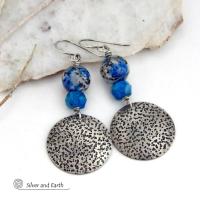 These handcrafted sterling silver earrings have a rustic, hand stamped texture and are accented with natural K2 granite and faceted blue apatite gemstones. This unique, interesting stone has beautiful blue azurite inclusions within a black and white speckled granite base. It was discovered in the foothills of world's second highest mountain, Mount K2, which it's name is derived from. The blue apatite was added to bring out the gorgeous blue inclusions in these stones. 