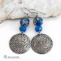 These handcrafted sterling silver earrings have a rustic, hand stamped texture and are accented with natural K2 granite and faceted blue apatite gemstones. This unique, interesting stone has beautiful blue azurite inclusions within a black and white speckled granite base. It was discovered in the foothills of world's second highest mountain, Mount K2, which it's name is derived from. The blue apatite was added to bring out the gorgeous blue inclusions in these stones. 