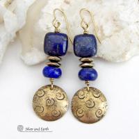 These handcrafted earrings feature round gold brass dangles with a hand stamped spiral texture. They are accented with natural lapis lazuli gemstones and faceted hematite stone beads with an electroplated champagne gold tone finish. The lapis stones are a rich shade of blue, along with natural gold pyrite inclusions. They have a modern chic, elegant style that coordinates beautifully with all wardrobe types - dressed up or down. Perfect for women that love unique artisan handcrafted jewelry