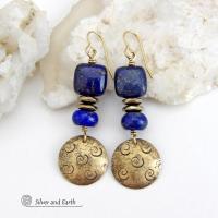 These handcrafted earrings feature round gold brass dangles with a hand stamped spiral texture. They are accented with natural lapis lazuli gemstones and faceted hematite stone beads with an electroplated champagne gold tone finish. The lapis stones are a rich shade of blue, along with natural gold pyrite inclusions. They have a modern chic, elegant style that coordinates beautifully with all wardrobe types - dressed up or down. Perfect for women that love unique artisan handcrafted jewelry