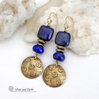 These handcrafted earrings feature round gold brass dangles with a hand stamped spiral texture. They are accented with natural lapis lazuli gemstones and faceted hematite stone beads with an electroplated champagne gold tone finish. The lapis stones are a rich shade of blue, along with natural gold pyrite inclusions. They have a modern chic, elegant style that coordinates beautifully with all wardrobe types - dressed up or down. Perfect for women that love unique artisan handcrafted jewelry
