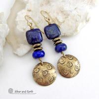 These handcrafted earrings feature round gold brass dangles with a hand stamped spiral texture. They are accented with natural lapis lazuli gemstones and faceted hematite stone beads with an electroplated champagne gold tone finish. The lapis stones are a rich shade of blue, along with natural gold pyrite inclusions. They have a modern chic, elegant style that coordinates beautifully with all wardrobe types - dressed up or down. Perfect for women that love unique artisan handcrafted jewelry
