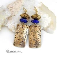 These earrings feature handcrafted brass rectangle dangles with a hand stamped texture accented with matte lapis lazuli gemstones and brass tribal style beads. They have an elegant modern style with boho chic flair that coordinates beautifully with all wardrobe styles. Perfect for women that love to wear unique artisan handcrafted jewelry. Handmade in the USA by Silver and Earth Jewelry.