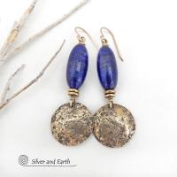 These handcrafted earrings feature beautiful long tube-shaped lapis lazuli gemstones accented with hammered gold brass dangles and tiny brass beads. The stones are a beautiful rich shade of blue with a sprinkling of natural sparkly pyrite inclusions. They have a modern, earthy chic elegance and can be worn with a variety of outfits - dressed up or down. Silver and Earth is a small business that makes beautiful handmade jewelry with high-quality natural materials. 