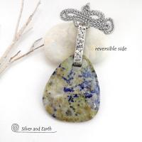 This one-of-a-kind necklace features a stunning natural gemstone comprised of natural lapis lazuli inclusions embedded in a calcite base. Lapis lazuli is formed with three minerals in varying amounts: lazurite, calcite, and pyrite. This stone has a unique matrix pattern with a blend of lapis with calcite which has a soft yellowish hue and a sprinkling of shimmery pyrite inclusions. Each side has it's own unique beauty, so I designed it to be reversible. 