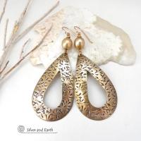 These gold brass hoop earrings have an intricate hand stamped texture and are accented with gold freshwater pearls. Big and bold, they're sure to make a statement! Long and dramatic - yet surprisingly lightweight to wear - despite their impressive appearance.