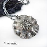 This handcrafted sterling silver necklace has a modern, earthy organic vibe. Perfect for everyday wear - it goes with everything. It features a large sterling silver circle with a rustic, hand forged texture and crimped ruffled edges.  Big and bold, it's sure to make an eye-catching statement. Handmade in the USA by Silver and Earth, a New Mexico True Certified business.  