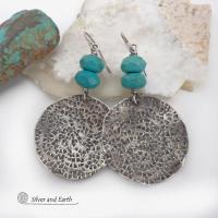 These handcrafted earrings feature large sterling silver round dangles with a hand stamped texture accented with natural turquoise gemstones with a faceted finish. Big and bold, they have a modern style with southwestern flair that looks great with all wardrobe types. Perfect for women that love large earrings and bold statement jewelry. Handmade in the USA by Silver and Earth Jewelry, a New Mexico True Certified business.