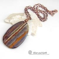Big and bold, this one of a kind pendant necklace features a large natural tiger iron gemstone with a copper wire bail. The stone has beautiful earthy hues of various shades of brown, smoky grey, rust and creamy bands of white. It's a gorgeous stone with a nice high polish. Sure to make a striking statement, it'll make a great gift for a natural stone lover.