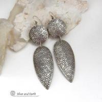 Bold, modern and contemporary - these long handcrafted sterling silver earrings feature an intricate hand textured design. They have an urban chic appeal and will look great with all wardrobe styles. They go with everything! Earrings are sturdy & substantial - yet lightweight and comfortable for all day wear.   MEASUREMENTS: Total length: 3" from top of sterling silver ear wires and 3/4” at widest point. Handmade in the USA by Silver and Earth Jewelry. 