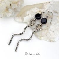 These handcrafted earrings have a contemporary modern and minimalist vibe. They feature hand forged solid sterling silver curvy sticks with a hammered organic texture topped off with coin-shaped black onyx gemstones.  Lightweight and fun to wear, they'll coordinate with all wardrobe styles and make a unique statement. Total length of approximately 3-1/4" from top of sterling silver ear wires and 3/8” at widest point of stone.