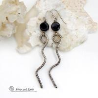 These handcrafted earrings have a contemporary modern and minimalist vibe. They feature hand forged solid sterling silver curvy sticks with a hammered organic texture topped off with coin-shaped black onyx gemstones.  Lightweight and fun to wear, they'll coordinate with all wardrobe styles and make a unique statement. Total length of approximately 3-1/4" from top of sterling silver ear wires and 3/8” at widest point of stone.