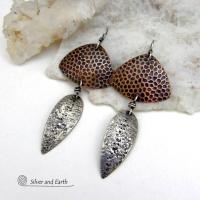 These sterling silver and copper mixed metal earrings have a modern, contemporary vibe. The copper has a dotted embossed pattern and the sterling dangles have a rustic hammered and stamped texture. Unique and versatile, the combination of metals will coordinate well with other copper and silver accessories in your wardrobe.