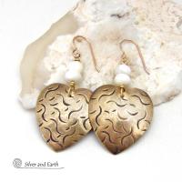 These handcrafted gold brass heart earrings have a hand stamped texture and are accented with white mother of pearl beads. They have a classic, modern style that coordinates beautifully with all wardrobe types. Full of romantic charm, they'll make a great gift for someone special on a birthday, wedding anniversary -- or any day! 
