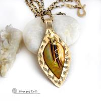 This necklace features a golden brown carved Mother of Pearl leaf accented against a handcrafted gold brass base. I hand sawed the base out of solid gold brass sheet and stamped the metal with a leaf pattern to "echo" the Mother of Pearl leaf. Unique and one-of-kind, it'll make a great gift for a nature lover - or a nice addition to your own jewelry wardrobe. It comes on an 18" antiqued brass chain with lobster claw closure. Handmade in the USA by Silver and Earth Jewelry. 