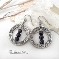 These handcrafted silver pewter hoop earrings have a hand stamped texture accented with black lava rock stones dangling in front. The stones have natural "pits" and crevices which is expected with porous lava stones. Lava stone is formed when molten rock erupts from an active volcano and comes in contact with the cool atmosphere of the Earth, which begins to solidify it. They have an earthy chic style that coordinates with all wardrobe types.