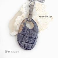 This one-of-a-kind necklace features a gorgeous natural Picasso marble gemstone accented with a hand forged sterling silver bail with a lightly hammered organic texture. The stone has earth tone shades of black, grey and some brown with an interesting matrix of abstract lines. This semiprecious stone is found only in southwest Utah. Makes a great gift for a natural stone lover - or a nice addition to your own jewelry wardrobe.