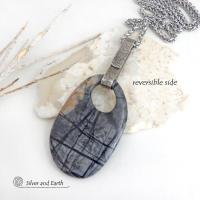 This one-of-a-kind necklace features a gorgeous natural Picasso marble gemstone accented with a hand forged sterling silver bail with a lightly hammered organic texture. The stone has earth tone shades of black, grey and some brown with an interesting matrix of abstract lines. This semiprecious stone is found only in southwest Utah. Makes a great gift for a natural stone lover - or a nice addition to your own jewelry wardrobe.