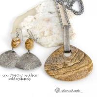 These handcrafted earrings feature natural picture jasper stones accented with textured sterling silver dangles. They have a modern, earthy design that looks great with all wardrobe styles. The stones have a natural pattern of brown streaks and black speckles against a tan background. I created the dangles out of solid sterling silver sheet; hammered them for an earth, organic texture; then oxidized them to enhance the detail. Earrings have a coordinating necklace sold separately. 
