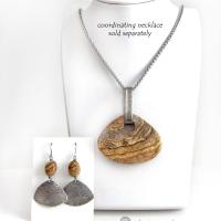 These handcrafted earrings feature natural picture jasper stones accented with textured sterling silver dangles. They have a modern, earthy design that looks great with all wardrobe styles. The stones have a natural pattern of brown streaks and black speckles against a tan background. I created the dangles out of solid sterling silver sheet; hammered them for an earth, organic texture; then oxidized them to enhance the detail. Earrings have a coordinating necklace sold separately. 