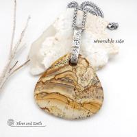 This one-of-a-kind necklace features a large stunning picture jasper stone accented with a handcrafted sterling silver bail. The stone has a beautiful natural pattern in various shades of brown, beige and gray. Big and bold, this necklace is a real statement piece - perfect for anyone that loves natural stones! 