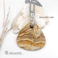 This one-of-a-kind necklace features a large stunning picture jasper stone accented with a handcrafted sterling silver bail. The stone has a beautiful natural pattern in various shades of brown, beige and gray. Big and bold, this necklace is a real statement piece - perfect for anyone that loves natural stones! 