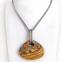 This handcrafted necklace features a large, chunky natural picture jasper stone accented with a handcrafted sterling silver bail. The stone has a beautiful natural pattern in various shades of brown, beige and gray. Big and bold, this necklace is a real one-of-a-kind statement piece - perfect for anyone that loves natural stones! It's reversible and can be worn on either side. Coordinating earrings sold separately. Handmade in the USA by Silver and Earth Jewelry.