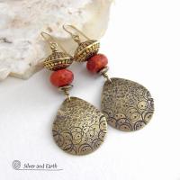 These handcrafted gold brass earrings have a hand stamped and hammered texture and are accented with faceted red coral, brass tribal style beads and faceted hematite stone beads with an electroplated champagne gold tone finish. Big and bold, they have a modern boho chic vibe with a tribal flair that makes a striking statement. Perfect for women that love to wear unique and eye-catching artisan handcrafted jewelry. Handmade in the USA by Silver and Earth Jewelry.