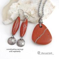 Simple and earthy - this pendant necklace features a natural red jasper gemstone with a wire wrapped sterling silver bail. The stone has a brick red hue with a natural matrix of beige streaks and dots. It has a modern minimalist appeal and is perfect for those that prefer simple, earthy jewelry. It has coordinating earrings which are sold separately. It makes a great gift for a natural stone lover - or a nice addition to your own jewelry wardrobe. Handmade in the USA by Silver and Earth Jewelry. 