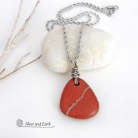Simple and earthy - this pendant necklace features a natural red jasper gemstone with a wire wrapped sterling silver bail. The stone has a brick red hue with a natural matrix of beige streaks and dots. It has a modern minimalist appeal and is perfect for those that prefer simple, earthy jewelry. It has coordinating earrings which are sold separately. It makes a great gift for a natural stone lover - or a nice addition to your own jewelry wardrobe. Handmade in the USA by Silver and Earth Jewelry. 