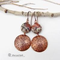 These handcrafted earrings feature natural rhyolite jasper stones accented with copper dangles with a rustic hammered texture. The stones have a natural earthy pattern with various shades of green, rusty orange, brown and cream. They have a casual and earthy style and will make a great gift for a natural stone lover - or a nice addition to your own jewelry wardrobe. Your choice of ear wires. Coordinating necklace sold separately. Handmade in the USA by Silver and Earth Jewelry.