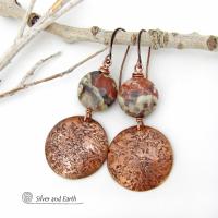 These handcrafted earrings feature natural rhyolite jasper stones accented with copper dangles with a rustic hammered texture. The stones have a natural earthy pattern with various shades of green, rusty orange, brown and cream. They have a casual and earthy style and will make a great gift for a natural stone lover - or a nice addition to your own jewelry wardrobe. Your choice of ear wires. Coordinating necklace sold separately. Handmade in the USA by Silver and Earth Jewelry.
