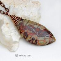 This necklace features a natural rhyolite jasper stone with a natural pattern in earthy hues of rusty orange, brown and taupe. It is wrapped in oxidized copper wire and comes on an 18" copper chain necklace. It has an earthy, natural style and will make a great gift for a natural stone lover - or a nice addition to your own jewelry collection. The chain can be removed from the pendant and worn with other pendants in your wardrobe. Coordinating earrings sold separately. 