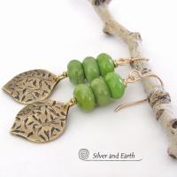 These handcrafted earrings feature gold brass dangles with a hand stamped texture accented with a stack of green serpentine gemstones. They have an earthy chic, modern style that coordinates well with all wardrobe types.These artisan-made earrings are perfect for adding a touch of earthy modern style to any outfit.  