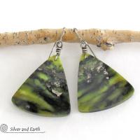 These one-of-a-kind earrings feature gorgeous slices of natural serpentine gemstones in hues of green and black, along with a sprinkling of sparkly pyrite inclusions. They have an earthy, modern style that looks great with all wardrobe types. Makes a great gift for a natural stone lover - or a nice addition to your own jewelry collection.