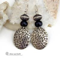 These sterling silver earrings have an earthy, southwestern tribal style. They feature hand textured sterling silver dangles accented with black buffalo horn and Native Navajo pearl style sterling silver beads with a rich, corrugated texture. Unique and striking, they'll make a bold statement. Handmade in the USA by Silver and Earth Jewelry. 