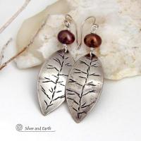 These handcrafted sterling silver leaf earrings have a delicate hand stamped texture and are accented with bronze freshwater pearls. They have a modern, earthy elegance that coordinates beautifully with all wardrobe styles. They'll make a great gift for a nature lover. Handcrafted exclusively in the USA by Silver and Earth Jewelry, a New Mexico True Certified business.