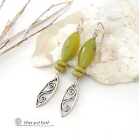 These sterling silver earrings have an earthy, classic and modern feel. They feature sterling silver leaf shapes with a scrolling spiral pattern accented with natural green serpentine gemstones. Lightweight and comfortable to wear, they'll coordinate with all wardrobe styles. 