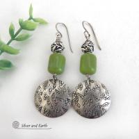Sterling silver earrings with a hand stamped leaf design accented with natural green serpentine stones and silver pewter beads. The stones have a lime green hue and the pewter beads have a beautifully detailed 3-dimensional carved pattern of vines and leaves. They have a modern, earthy style and will make a great gift for a nature lover.  These artisan-made earrings are perfect for adding a touch of earthy modern style to any outfit. 