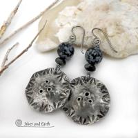 Handcrafted earrings with a modern bold edgy vibe. They feature rustic hammered and hand stamped silver tone pewter dangles accented with natural snowflake obsidian gemstones. The stones have a natural pattern in hues of black and soft gray. This stone is a natural volcanic glass which contains the mineral cristobalite - which creates the "snowflake" type patterns. Bold and striking - they're sure to make a statement. Perfect for women that love natural stones and unique artisan handmade jewelry. 